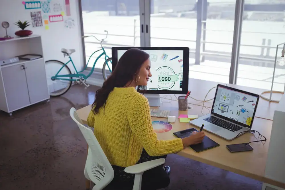 Woman engaged in online eLearning Design Essentials training on a laptop